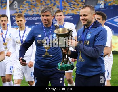 KYIV, UKRAINE - APRIL 25, 2021: FC Dynamo Kyiv assistant coaches Emilian Karas (L) and Oleh Husiev pose with the Trophy of the winners of Ukrainian Premier League 2020-21 at NSC Olimpiyskiy stadium Stock Photo