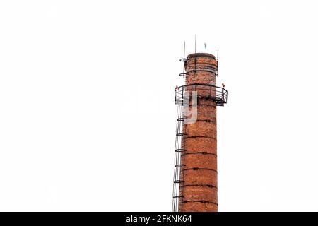 Old brick smokestack isolated on white background. Old factory chimney. Red brick victorian manufacture chimney Stock Photo