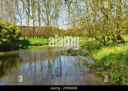 The River Crane runs at the rear of Cranborne Manor and within the grounds of the manor house Stock Photo