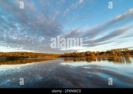 Scenic view of dramatic clouds reflected in Lake Inverell in late afternoon sunlight, Inverell, New South Wales, Australia Stock Photo