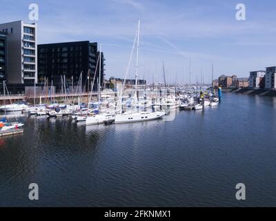 Expensive leisure craft moored in Cardiff Marina Penarth Vale of Glamorgan South Wales UK redeveloped dock area on lovely April day Stock Photo