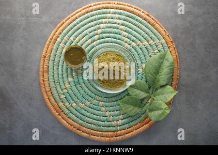 The wooden bowl with rehydrated henna on table  Stock Photo