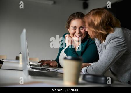 Joyful female telling something to her boss Stock Photo