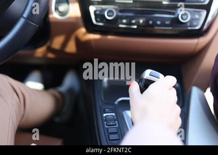 Woman hand holding automatic transmission lever closeup Stock Photo