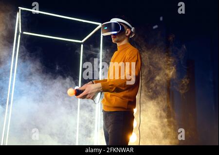Male gamer using virtual reality headset Stock Photo