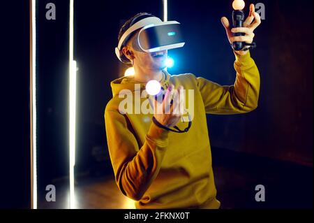 Male gamer using virtual reality headset Stock Photo