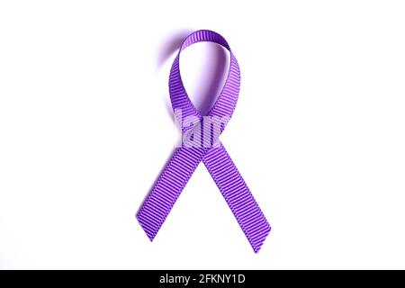 Purple awareness ribbon represents pancreatic cancer, alzheimer's disease, lupus, animal abuse, ADD and religious tolerance. Isolated on white backgro Stock Photo