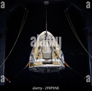 The SpaceX Crew Dragon Resilience spacecraft is lifted onto the GO Navigator recovery ship after it landed with NASA astronauts Mike Hopkins, Shannon Walker, and Victor Glover, and Japan Aerospace Exploration Agency (JAXA) astronaut Soichi Noguchi aboard in the Gulf of Mexico off the coast of Panama City, Florida, Sunday, May 2, 2021. NASA's SpaceX Crew-1 mission was the first crew rotation flight of the SpaceX Crew Dragon spacecraft and Falcon 9 rocket with astronauts to the International Space Station as part of the agency's Commercial Crew Program. Photo Credit: (NASA/Bill Ingalls) Please Stock Photo