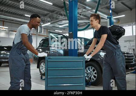 Two male workers at the toolbox, car service Stock Photo