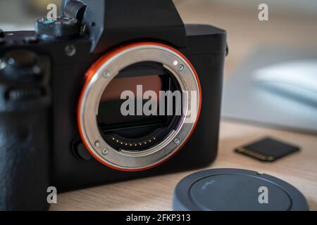 a system camera on table with a sd card in backround Stock Photo