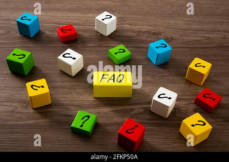 FAQ word on colour wooden block on top of wooden table Stock Photo