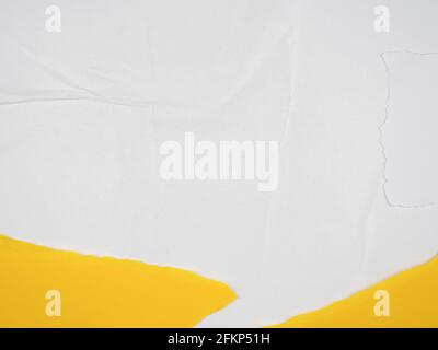 Old ripped torn paper background in white, yellow, blue colors. Blank creased crumpled dirty posters grunge textures placard surface Stock Photo