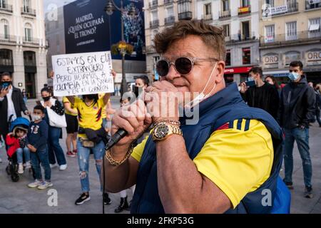 Madrid, Spain. 02nd May, 2021. A protester speaks through a microphone during the demonstration.Thousands of Colombians took to the streets to protest against a government tax reform proposal. Protests continued despite an announcement by Colombia's President Ivan Duque late Friday that he would scrap the bill's unpopular clauses. Credit: SOPA Images Limited/Alamy Live News Stock Photo