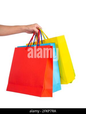 Hand holding multicolored paper bags isolated on white; shopping concept Stock Photo