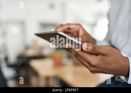 Closeup of an African businessman using a digital tablet Stock Photo