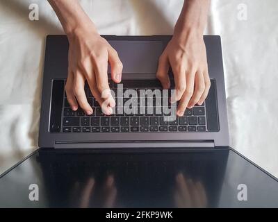 Male hands typing on laptop keyboard, working concept Stock Photo