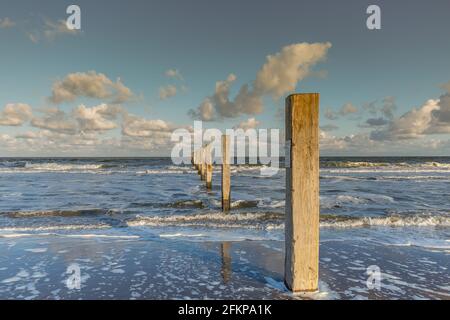 Very beautiful sunset on the North Sea beach near Langevelderslag at Project strandreservaat Noordvoort in Noordwijk with orange colored clouds and bo Stock Photo