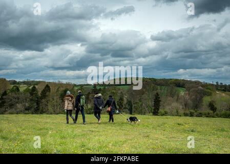 Chorleywood, UK.  3 May 2021.  UK Weather: People walking under ominous grey clouds gathering over Chorleywood House Estate, Hertfordshire on May’s early Bank Holiday Monday.  The forecast is for conditions to worsen with heavy rain and strong winds towards the end of the day.  Credit: Stephen Chung / Alamy Live News Stock Photo