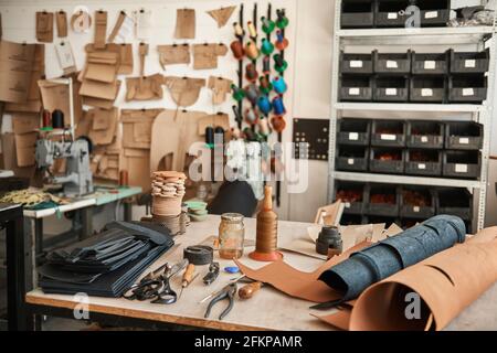 Tools and material sitting on a leather studio workbench Stock Photo