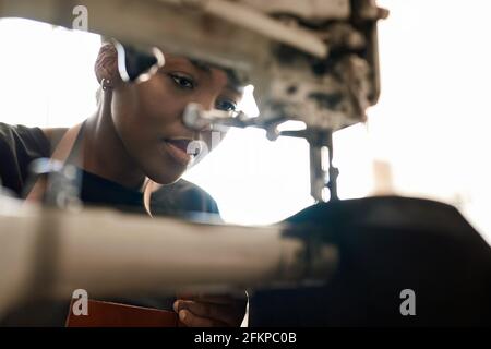 Young African female artisan working on a sewing machine Stock Photo