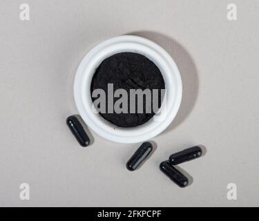 Activated charcoal powder for facial mask. Natural beauty treatment and spa. Beauty concept. Close up. Top view. Stock Photo