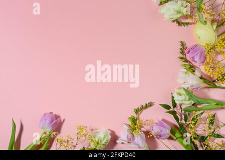 Floral border on pink background. Copy space, top view, flat lay. Stock Photo