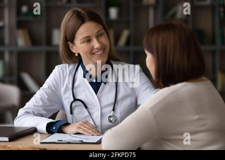 Smiling female doctor support senior woman patient