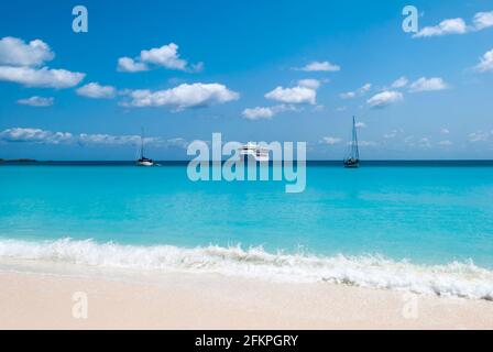 The cruise ship and two yachts are drifting near Half Moon Cay island beach (Bahamas). Stock Photo