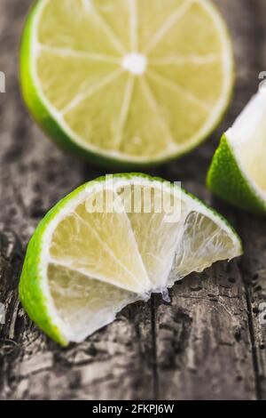Closeup of sliced limes on old wood Stock Photo