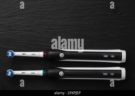Frankfurt, Germany - May 1, 2021: Two Electric toothbrush Oral-B Cross Action PRO 750 black edition on black background Stock Photo