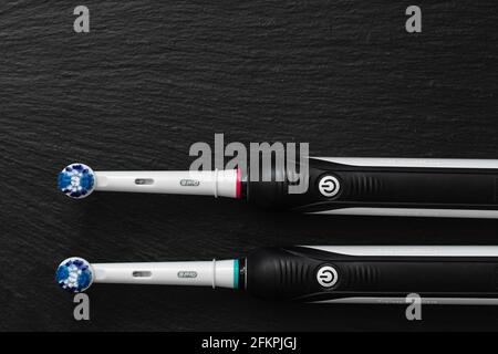 Frankfurt, Germany - May 1, 2021: Two Electric toothbrush Oral-B Cross Action PRO 750 black edition on black background Stock Photo