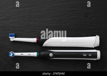 Frankfurt, Germany - May 1, 2021: Two Electric toothbrush Oral-B Cross Action PRO 750 black edition on black background Stock Photo