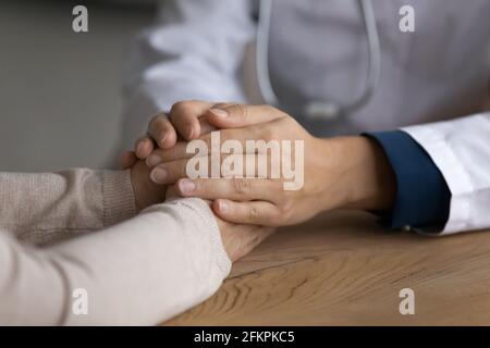 Close up of female doctor hold hands of senior patient Stock Photo