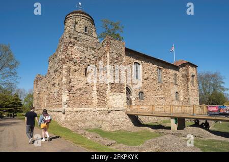 Colchester, view in summer of young people walking in the Castle Park beside the castle, parts of which date from 1st Century AD, Colchester Essex, UK Stock Photo