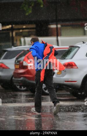 Stroud, UK, 3rd May, 2021. UK Weather. Gusty winds and rain hits shoppers on Bank Holiday Monday in Stroud, Gloucestershire. Credit: Gary Learmonth / Alamy Live News Stock Photo