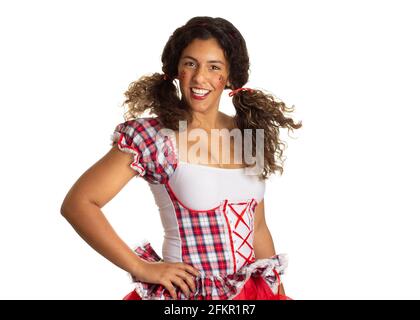 Festa Junina in Brazil, known as brazilian June Party. Playful mixed race Girl wearing traditional clothes. Stock Photo