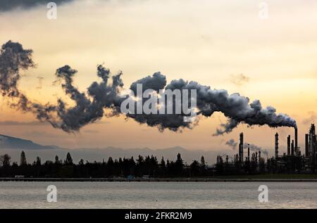 WA19563-00...WASHINGTON - Smoke produced at oil refineries at March Point on Fidalgo Bay near Anacortes. Stock Photo