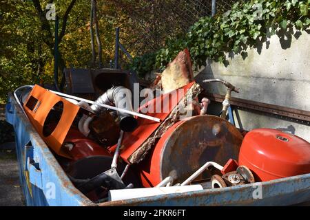 Scrap metal collected in a container in a community disposal place. A public service free of charge to prevent littering the environment. Stock Photo