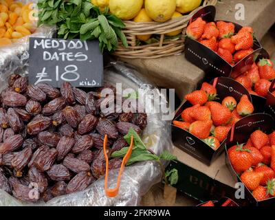 Fresh fruit for sale including Medjool dates, Punnets of Strawberries, lemons and dried apricots. Stock Photo