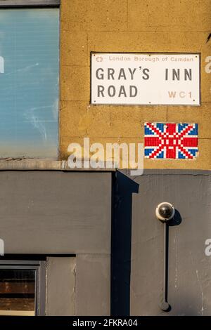 Gray's Inn Road Street Sign London - Grays Inn Rd street sign with Union Jack Flag Space Invader mosaic. Stock Photo