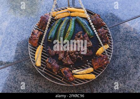 Top View of Grilled Meat and Vegetables on Backyard Barbecue Grill Stock Photo