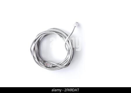 Twisted pair grey network Internet cable isolated over white background. Top view. Stock Photo