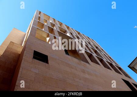 Modern sandstone rectalinear building as shot from below with crisp blue sky in the background. Murcia City Hall, Murcia, Spain by Rafael Moneo Stock Photo