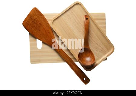 Wooden eco-friendly tableware. Wooden plate, spoon, cutting board, spatula. Isolated on a white background. Selective focus. Stock Photo