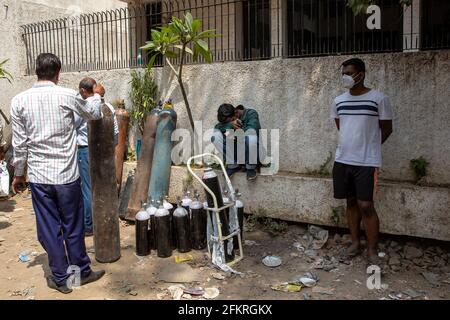 New Delhi, India. 28th Apr, 2021. A young man looks blankly as he waits for his turn to get his oxygen cylinder refilled at a plant in New Delhi, India on April 28, 2021. A massive spike in Covid-19 cases has overwhelmed the medical infrastructure with oxygen running out at major hospitals across the national capital. Forcing people to stand in long lines to source oxygen for their relatives both at home and others in hospitals. (Ishan Tankha/Sipa USA) Credit: Sipa USA/Alamy Live News Stock Photo