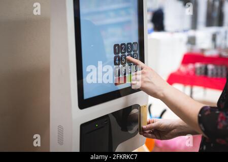 automated machine, paying with credit card in shopping center Stock Photo