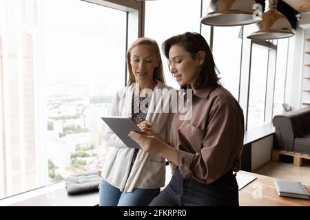 Female employees use modern tablet for work Stock Photo
