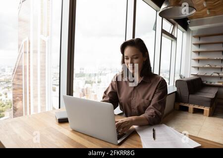 Successful businesswoman work on laptop in modern office Stock Photo