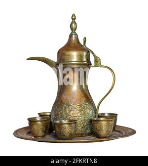 Turkish coffee set: Ottoman ornate coffee pot and small ornate cups, isolated on white with clipping path Stock Photo