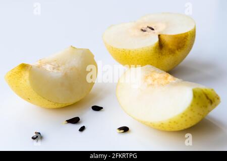 Closeup of a cut opened Korean pear isolated on a white background. Stock Photo